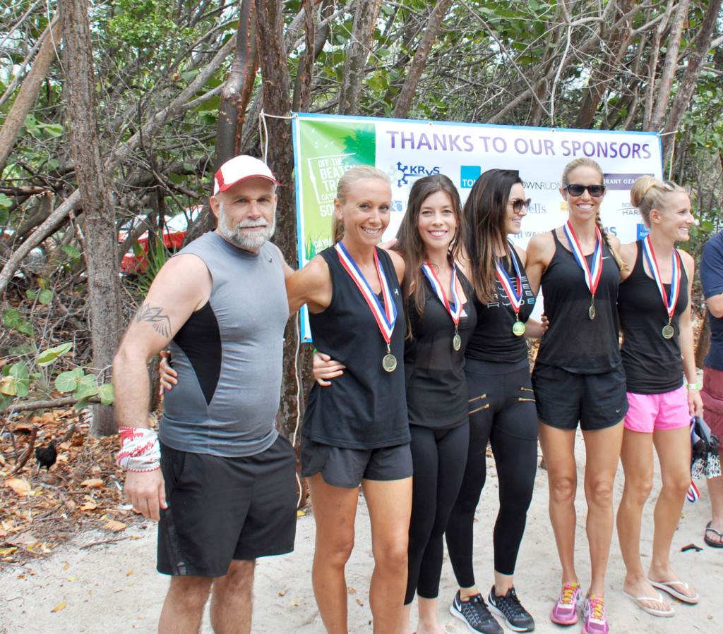 Sole Sisters, 1st place Female Relay Team in the 2017 race, receive their award from lead race sponsor and founder Kenneth Krys of KRyS Global.
